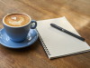 Coffee and notebook on a desk